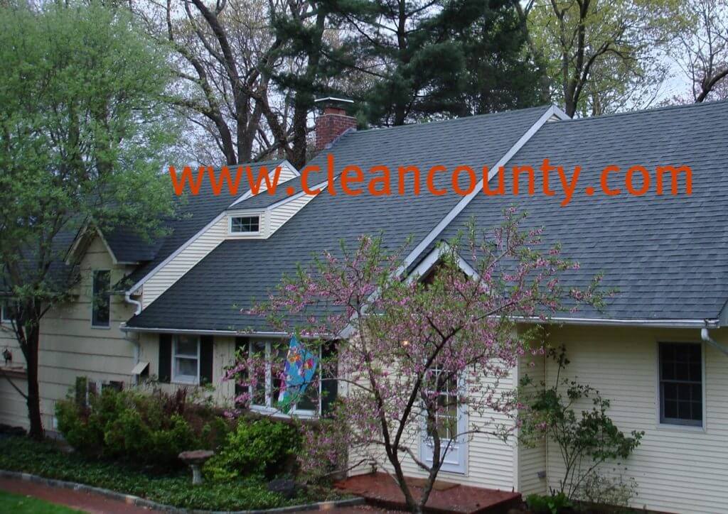 SoftWash Low Pressure Roof Cleaning Don’t replace your roof — restore it instead! Clean County provides professional roof cleaning services that protect the long life, curb appeal, and quality of your shingles. A Solution For Black Stains If you live in the Tri State area, it’s likely that you’ve run into the “black stain” issue on roofs. Many homes in the area have dark striped running down their shingles. The responsible party? A type of bacteria called Gloeocapsa Magma, which looks like algae and feeds on the limestone in your shingles. When Gloeocapsa Magma takes hold, it eats away at your roofing. This introduces issues like: