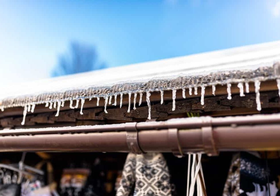 hanging-icicles-from-the-roof-of-a-wooden-building-GQPCP9X