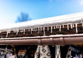 hanging-icicles-from-the-roof-of-a-wooden-building-GQPCP9X